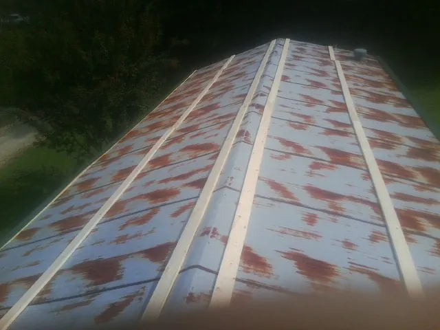 Rusted metal roof panels with new wood purlins before replacement — Storm Damage Roof Repair in Claysville by Roofing Brothers