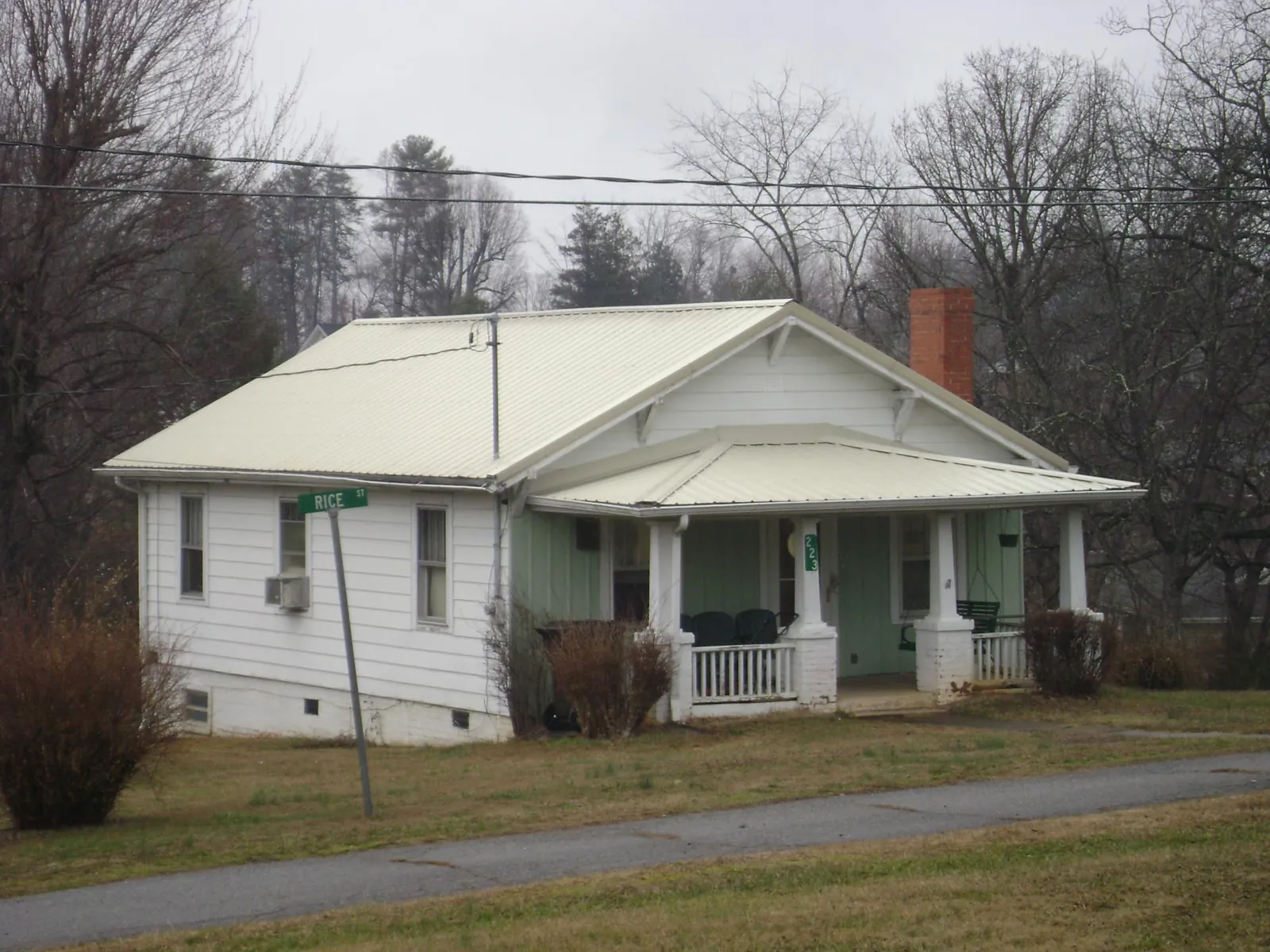 White metal roof on a craftsman bungalow at a street corner in Claysville